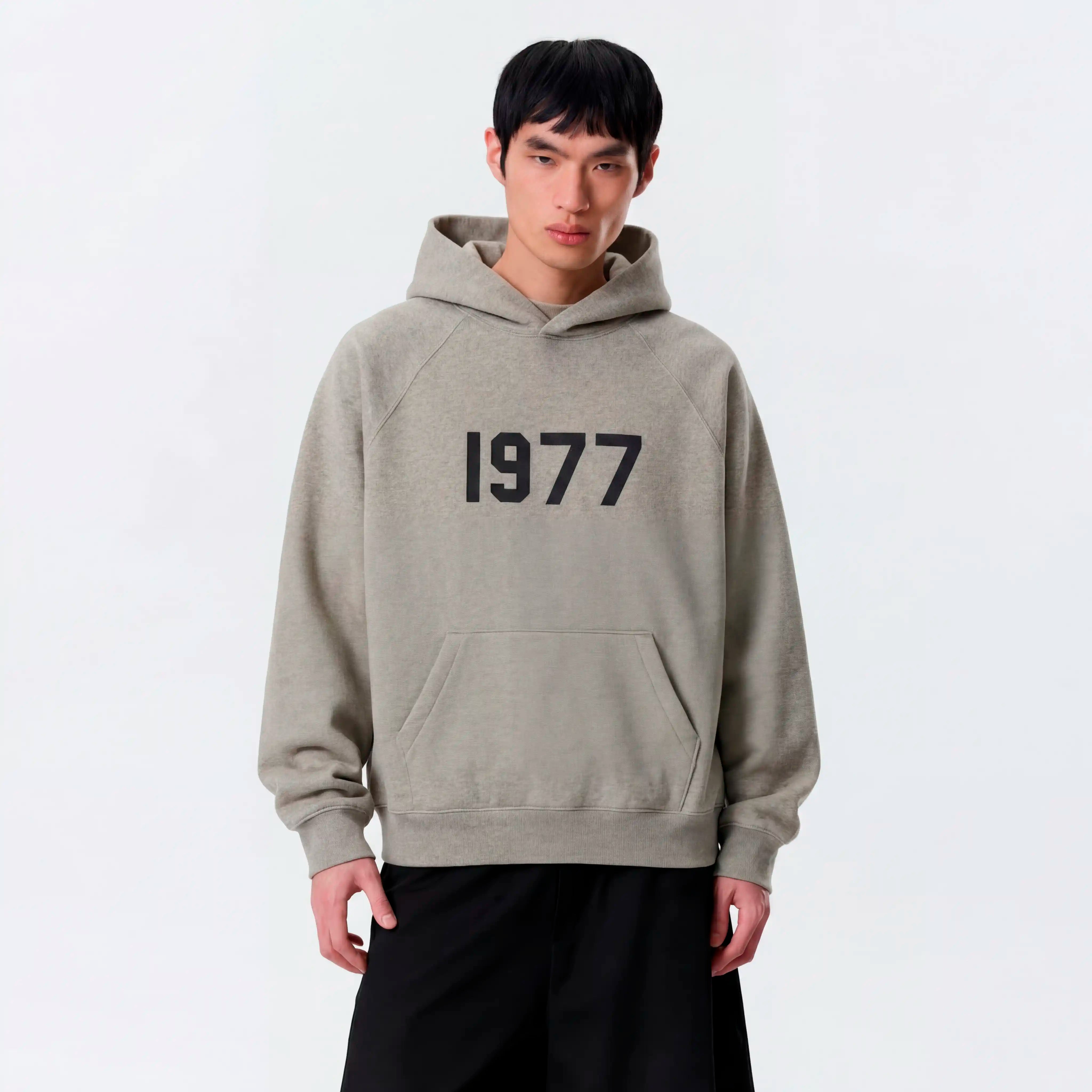 Model wearing essentials 1977 dark oatmeal hoodie