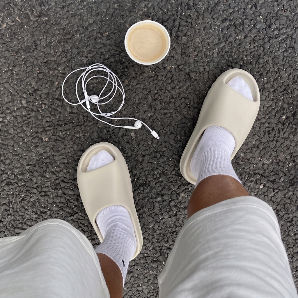 Model wearing cream yeezy slides