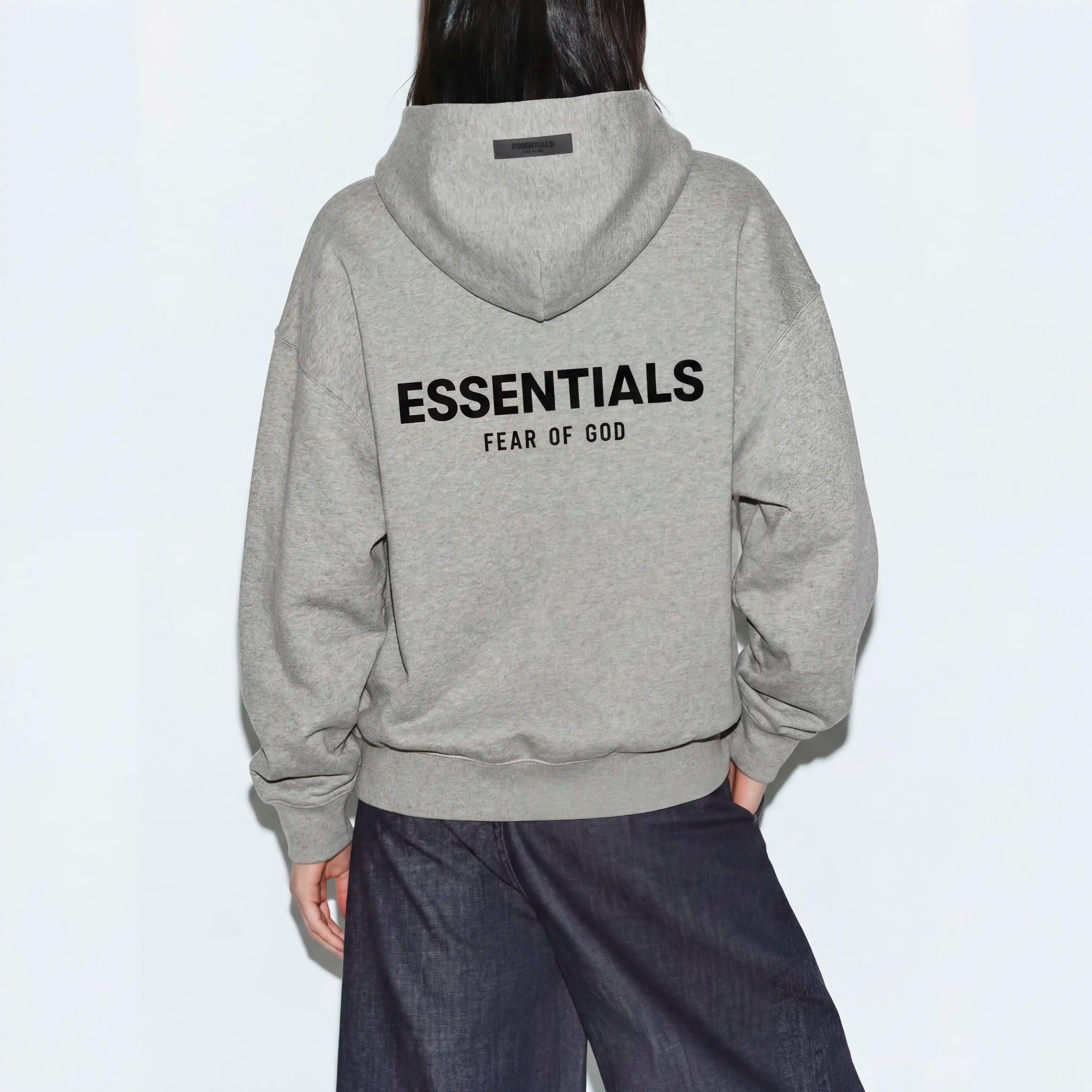 Female model wearing essentials dark oatmeal hoodie