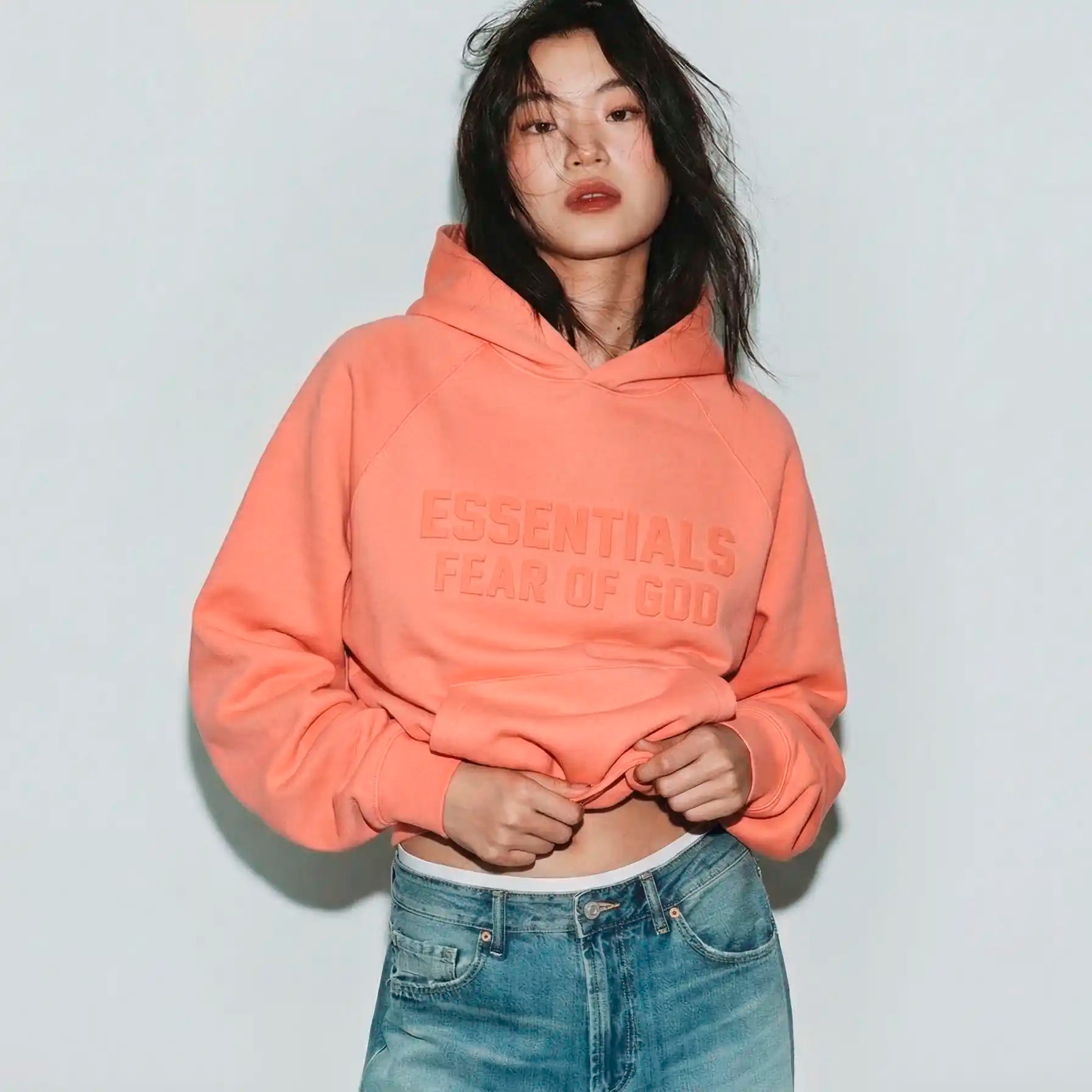 Essentials Coral Hoodie on a model