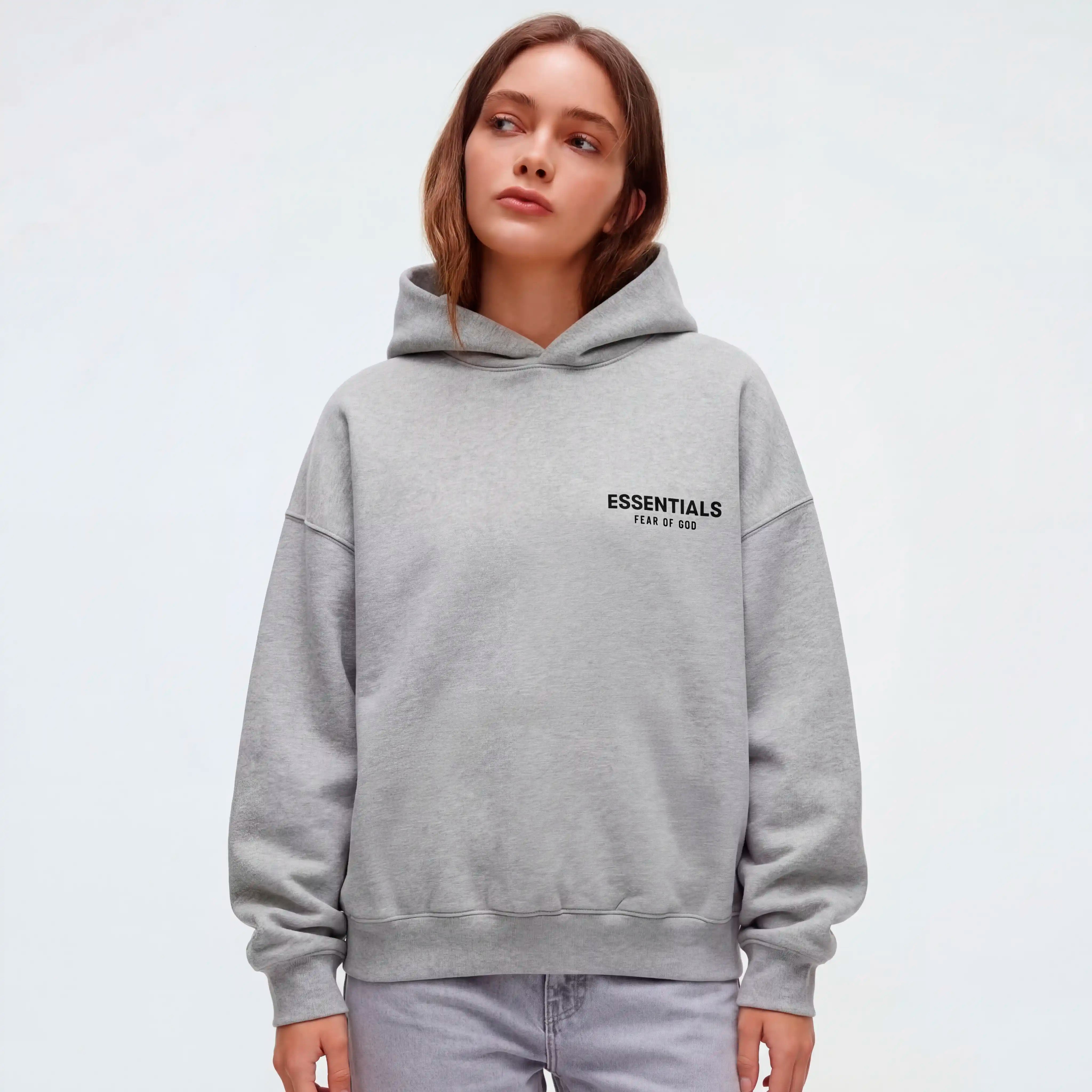 Female model wearing Essentials light heather gray hoodie