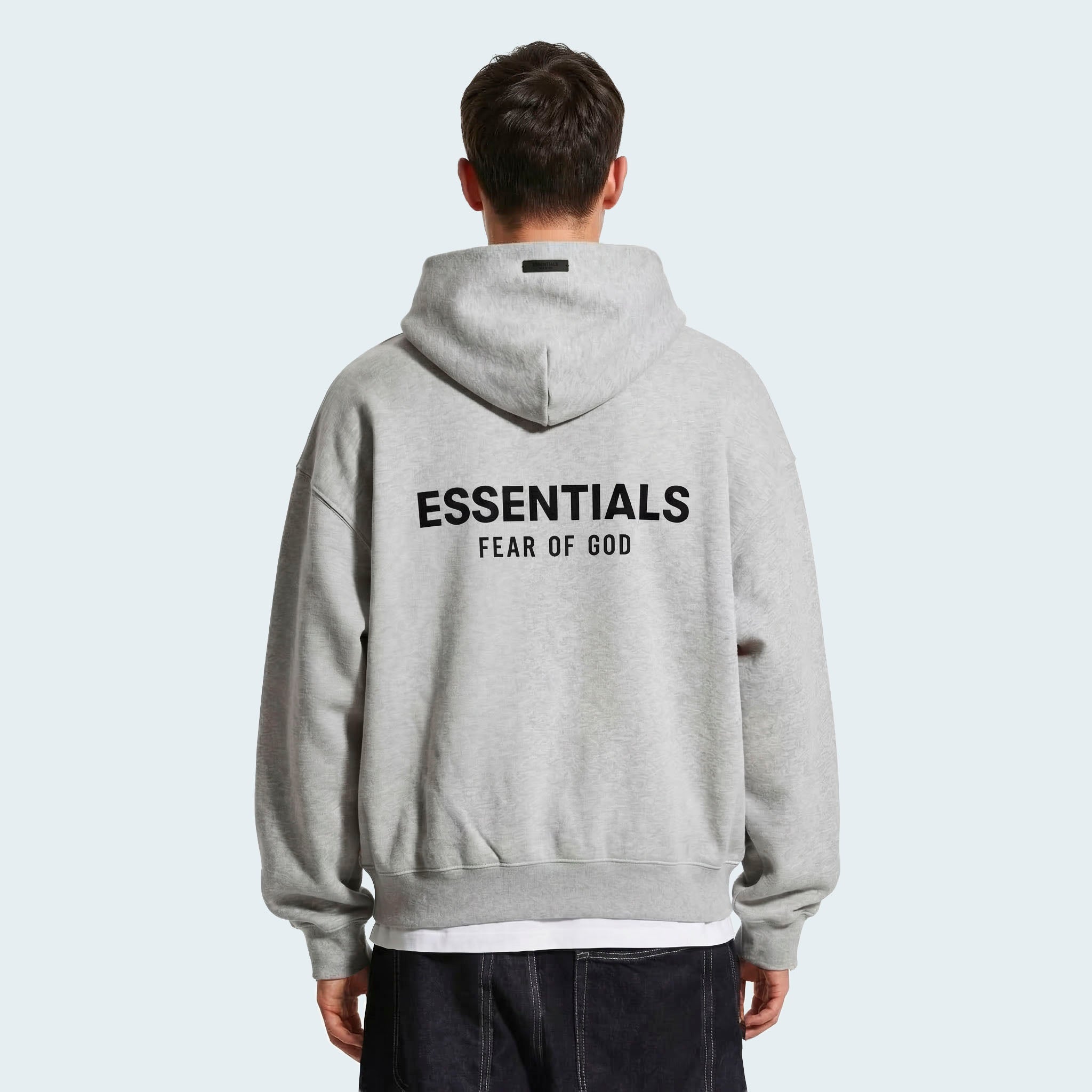 Male model wearing essentials light heather grey hoodie