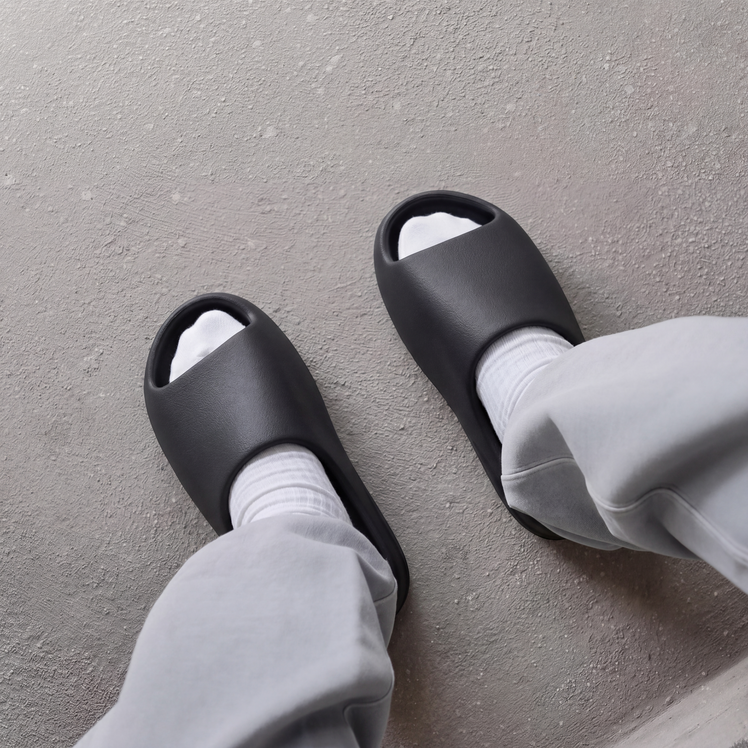 Model wearing YS-01 Yeezy Slides in black colorway 