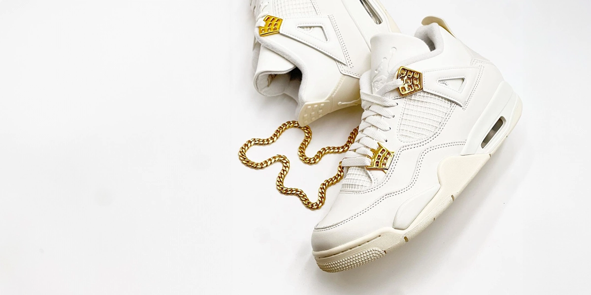 Metallic Gold Air Jordan 4 kengät kultaisen kaulakorun vieressä